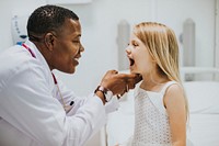 Young girl showing a dentist her teeth