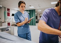 Young female nurse taking notes
