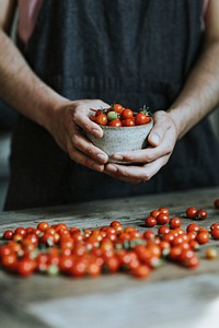 Chef cooking with red cherry tomatoes