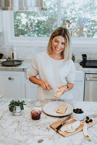 Woman spreading vegan cream cheese on a toast