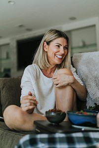 Cheerful woman talking with her boyfriend on the couch
