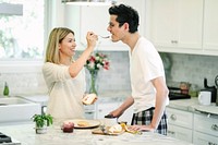 Woman feeding blackberry jam to her boyfriend