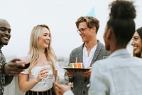 Cheerful friends celebrating at a rooftop birthday party