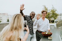 Diverse friends getting their picture taken at a rooftop party