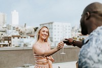 Cheerful friends toasting at a rooftop party