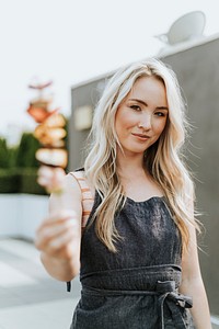 Cheerful woman with a barbeque skewer