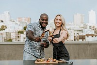Happy couple enjoying a barbeque skewer and a glass of wine