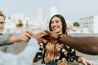 Friends toasting at a rooftop party