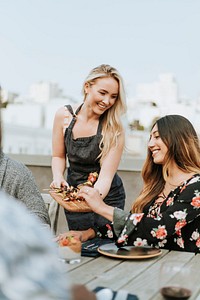 Woman serving her friends vegan barbeque skewers