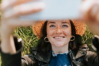 Woman taking a selfie in a park