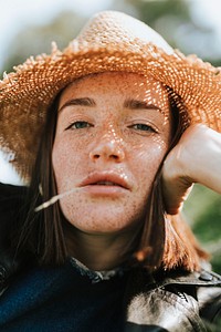 Portrait of a beautiful young woman with freckles