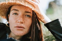 Portrait of a beautiful young woman with freckles