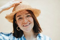 Portrait of a cheerful woman wearing a straw hat