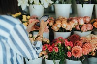 Woman messaging in a flower shop
