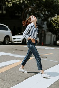 Casual woman crossing the street in downtown, San Francisco