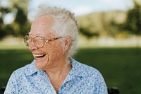 Cheerful senior woman sitting in the park