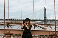 Photographer taking a photo at the Brooklyn Bridge, USA