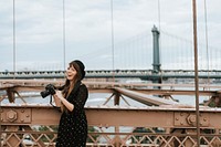 Photographer taking a photo at the Brooklyn Bridge, USA