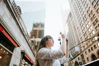 Woman taking a photo of the view in New York City, USA