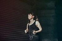 Beautiful woman listening to music while running 