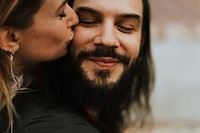 Woman giving her boyfriend a kiss