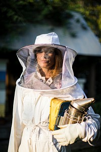 Beekeeper posing with the smoker