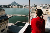 Western woman enjoying a view of Pushkar lake in Rajasthan