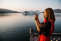 Western woman capturing the view of Udaipur city, India