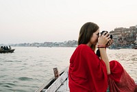 Traveler on a boat taking photos from the River Ganges