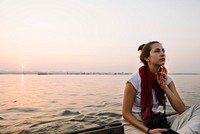 Female photographer sitting on a boat on the River Ganges