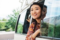 Happy woman enjoying the view from a van