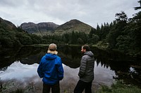 Friends standing by the riverside in the Highlands