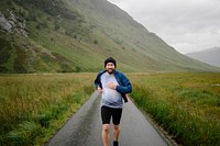 Exhausted and happy man jogging through the highlands