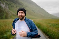 Exhausted and happy man jogging through the highlands