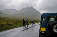 Friends walking down a road in the Highlands