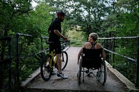 Couple exercising together on a bicycle and in a wheelchair