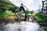 Female cyclist in action over a puddle
