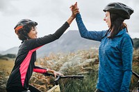 Female cyclists giving a high five