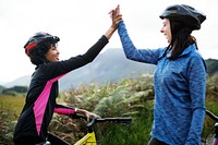Female cyclists giving a high five