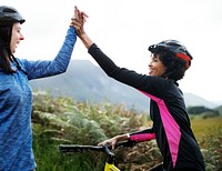 Female cyclists giving a high five