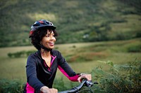 Cheerful female cyclist enjoying a bike ride
