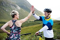 Cyclists giving each other a high five