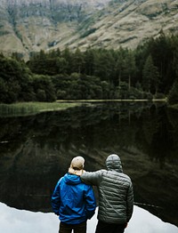 Friends standing by the riverside in the Highlands
