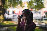 Woman taking photos with a vintage film camera