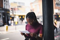 Woman with braids checking a city map