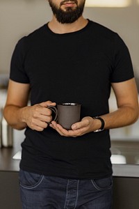 A man holding a black coffee cup in his hands