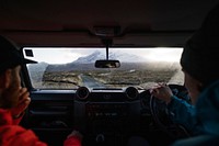 Man driving a car with a friend in the Highlands, Scotland