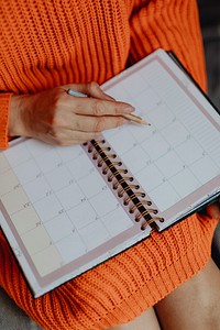 Woman writing on her daily planner