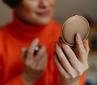 Woman spraying perfume before heading out
