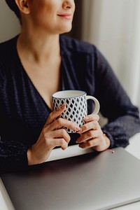 Woman holding a ceramic mug